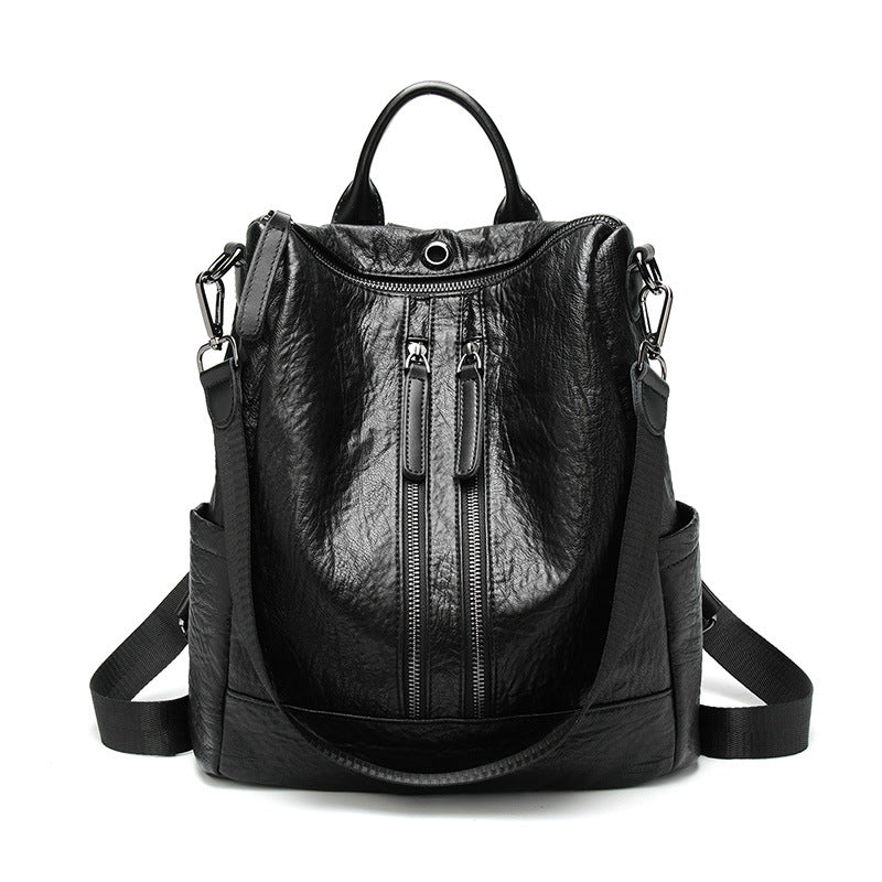 Black soft leather multifunctional backpack with dual front zippers, top handle, and adjustable shoulder straps.
