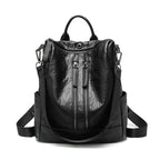 Black soft leather multifunctional backpack with dual front zippers, top handle, and adjustable shoulder straps.