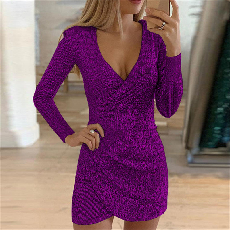 A woman wears a long-sleeve, deep V-neck, purple sequined mini dress with a ruched, irregular wrap-style skirt.