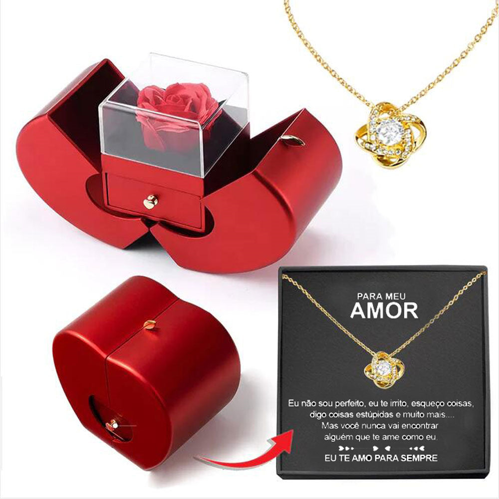 Red apple-shaped jewelry box with an eternal rose, clear display case, and a gold knot pendant necklace with message.