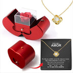 Red apple-shaped jewelry box with an eternal rose, clear display case, and a gold knot pendant necklace with message.