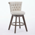 Beige tufted velvet swivel bar stool with nailhead trim on weathered wooden legs.