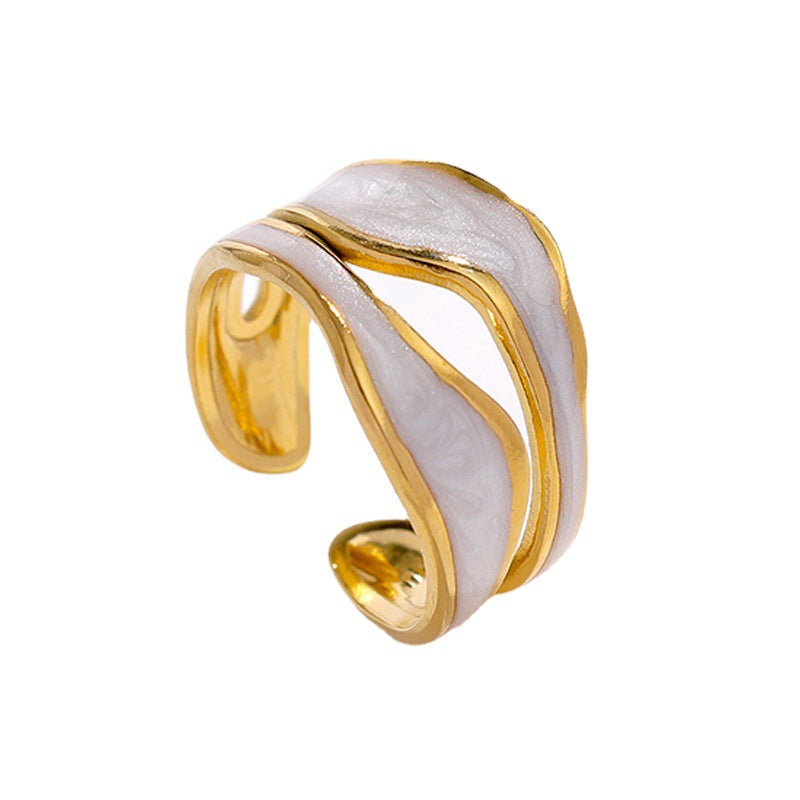 Gold titanium steel open-toed ring with wavy, iridescent white enamel inlay on a white background.