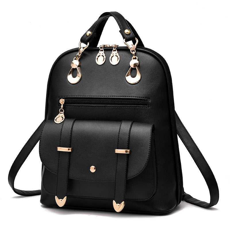 Black PU leather backpack with gold-tone hardware, front pocket with buckle straps, and top handle, white background.