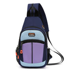 Navy, light blue, and purple canvas sling backpack with zippered pockets, mesh side pocket, and orange accents.