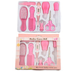 Pink baby grooming kit with plastic brush, comb, digital thermometer, nasal aspirator, dropper, clipper, and scissors.