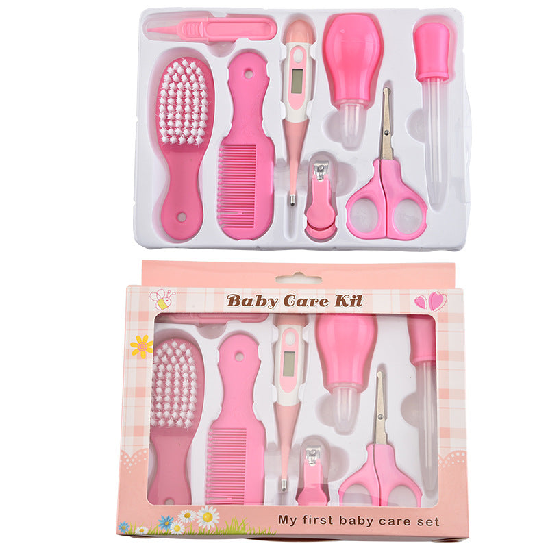 Pink baby grooming kit with plastic brush, comb, digital thermometer, nasal aspirator, dropper, clipper, and scissors.