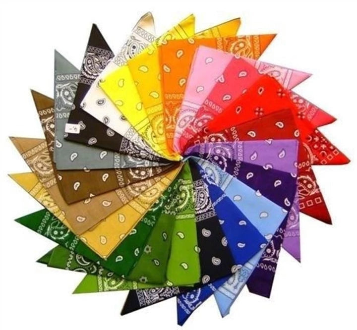 A color wheel of folded square cotton bandanas featuring traditional paisley patterns in a rainbow of vibrant colors.