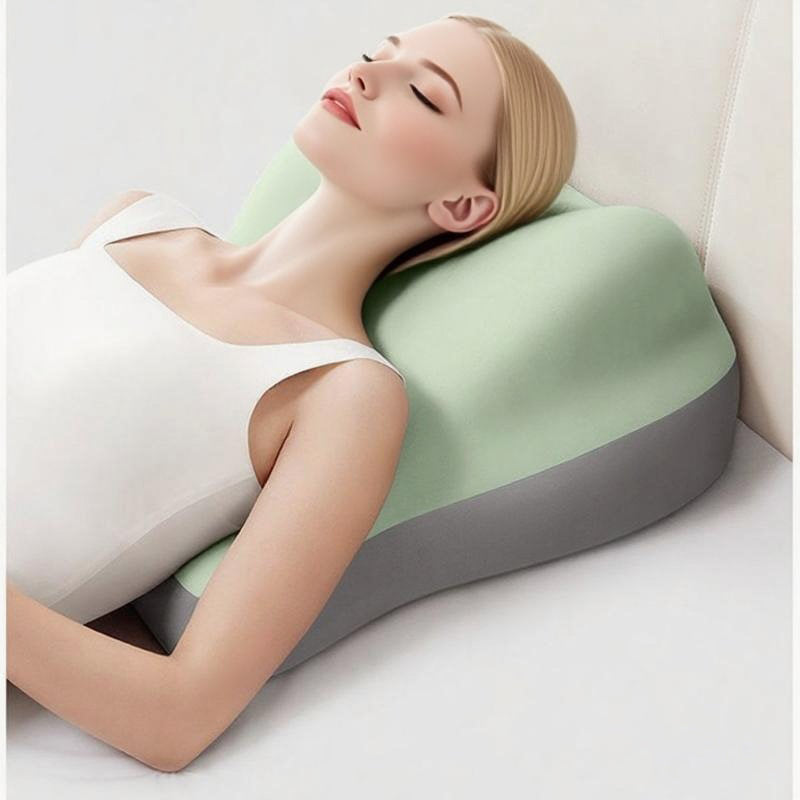 A woman rests on a contoured, two-tone sage green and grey memory foam pillow designed for supportive sleep.