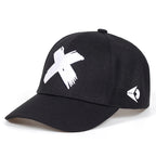 Black baseball cap with a white embroidered "X" on the front and a small geometric logo on the side.