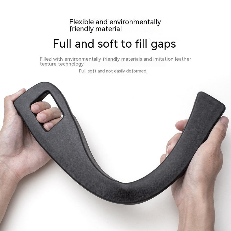 Hands holding a flexible, black, faux-leather car seat gap filler designed to stay soft and hold its shape.