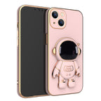Pink phone case with gold electroplated trim and a 3D astronaut figure that serves as a kickstand.