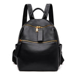Small black pebble-grain leather women's backpack with gold zippers, top handle, and adjustable shoulder straps.