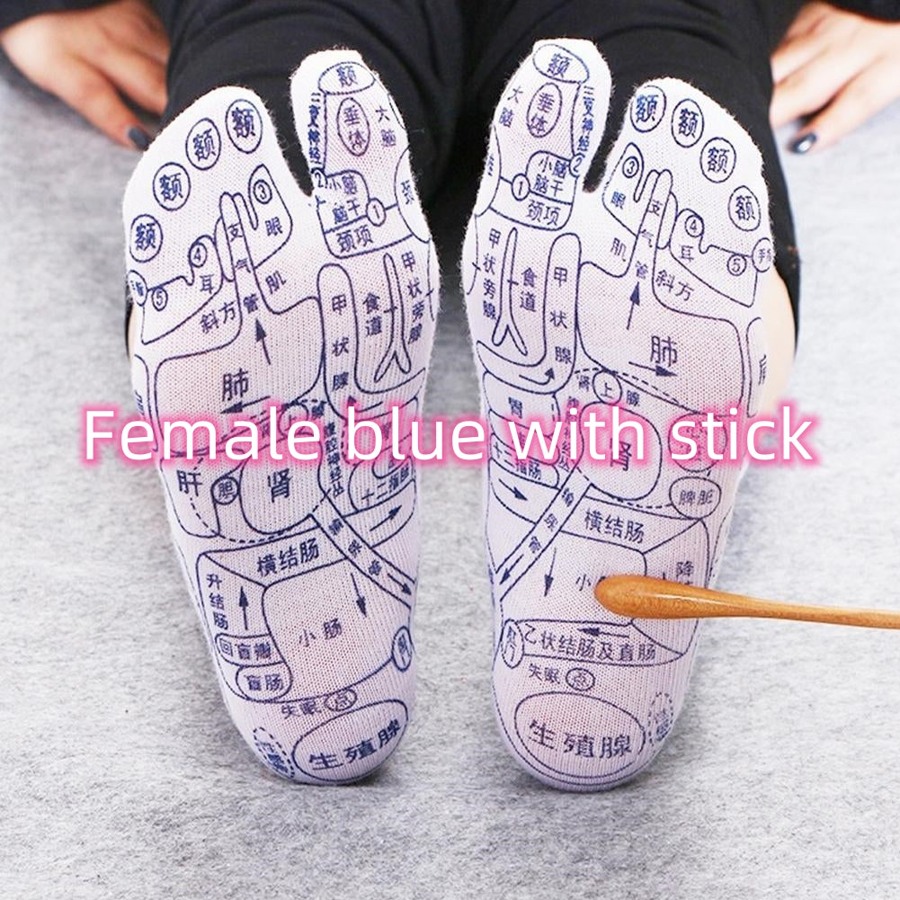 White acupressure reflexology socks with black Chinese character point maps, worn on feet, shown with a massage stick.