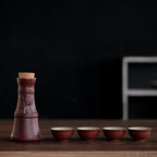 A brown, rustic ceramic sake set with a cork-topped decanter and four ribbed cups on a wooden table.