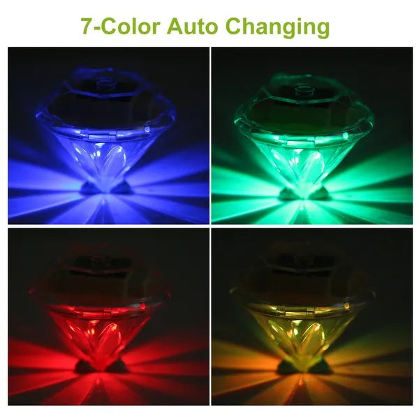 Four diamond-shaped solar LED lights glowing in different colors against a black background.
