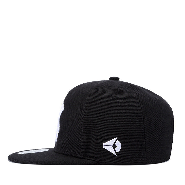 Black hip-hop snapback hat with a white embroidered logo on the side and a flat brim, isolated on a white background.