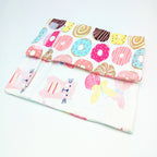 Portable USB bottle warmer with a donut-patterned top flap and a white base featuring cat and butterfly prints.