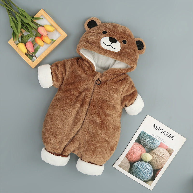 Brown fuzzy baby onesie with a bear-face hood, white cuffs, and zipper closure on a gray background.