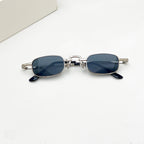 Retro rectangular hip-hop sunglasses with silver metal frames, detailed temples, and dark lenses on a white background.
