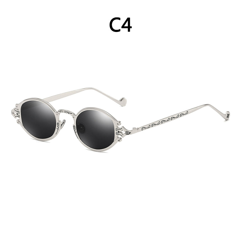 Silver steampunk sunglasses with round black lenses and ornate, engraved metal frames.