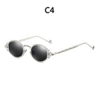 Silver steampunk sunglasses with round black lenses and ornate, engraved metal frames.