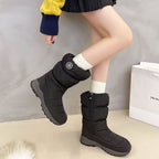 Black, mid-calf, quilted cotton snow boots with side zippers, circular logo, and thick gray lug soles on a model.