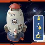 White and grey rocket water sprinkler toy with a bear astronaut graphic, red accents, and included hose attachments.