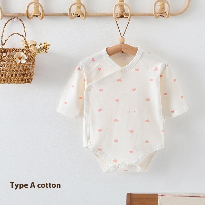 White long-sleeve cotton newborn baby romper with pink heart print, wrap-style front, and bottom snap closures.