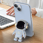 Light blue anti-drop phone case with a 3D electroplated gold-trimmed astronaut kickstand on the back.
