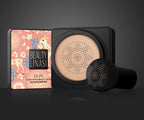 A Beauty Linasi air cushion BB cream with a patterned box and a black mushroom-head applicator on a grey background.