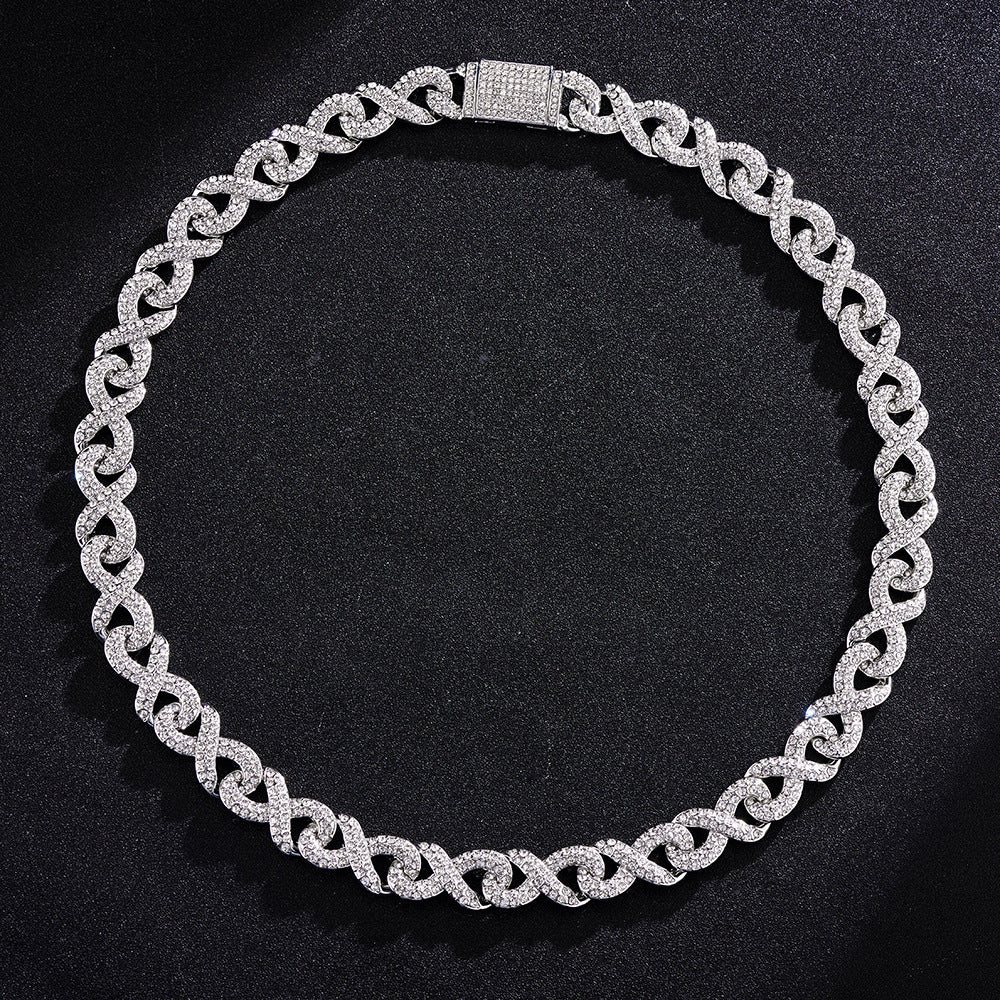 Silver-toned hip hop chain featuring infinity-shaped links encrusted with sparkling crystals against a black background.