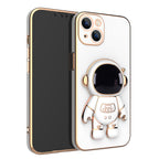 White phone case with gold electroplated trim and a 3D astronaut figure acting as a stand on the back.