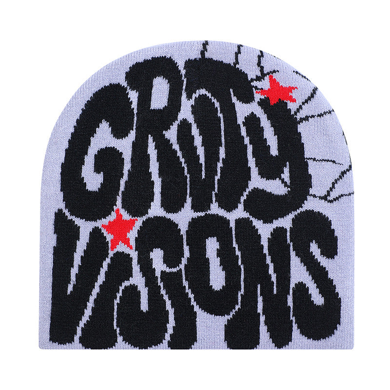 Light purple knit beanie with bold black "GROOVY VISIONS" text, spiderweb detail, and small red star accents.