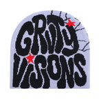 Light purple knit beanie with bold black "GROTY VISONS" text, red star accents, and black web detail.