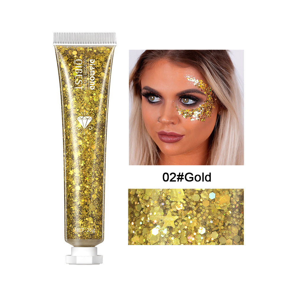 Gold glitter gel in a 25g squeeze tube, shown applied to a model's face, featuring holographic star and hexagon shapes.