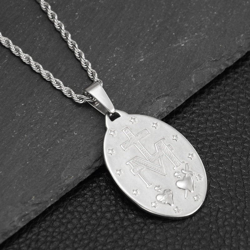 Silver titanium steel necklace with an oval pendant featuring an engraved cross, monogram, hearts, and stars.