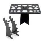 Black acrylic makeup brush drying rack and storage stand with multiple slots for organizing cosmetic tools.