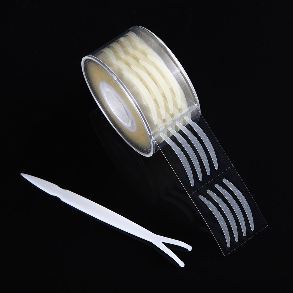 Clear beige double eyelid tape roll with a white applicator tool on a black background.