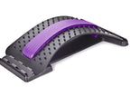 Black arched lumbar stretcher with a purple foam center strip and acupressure massage nubs on a white background.