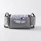 Grey baby stroller organizer bag with side cup holders and a flap featuring a whimsical arctic animal print.