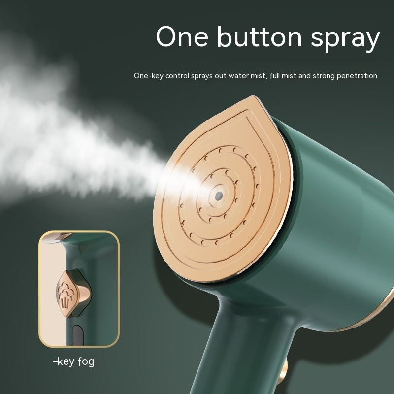Dark green portable garment steamer with a gold-toned iron plate emitting steam and a single steam button.