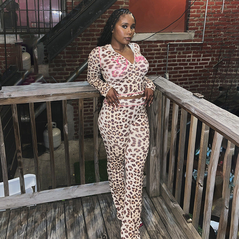 Woman in a leopard print high-waisted pant set with a zip-up hoodie featuring pink contrast stitching.