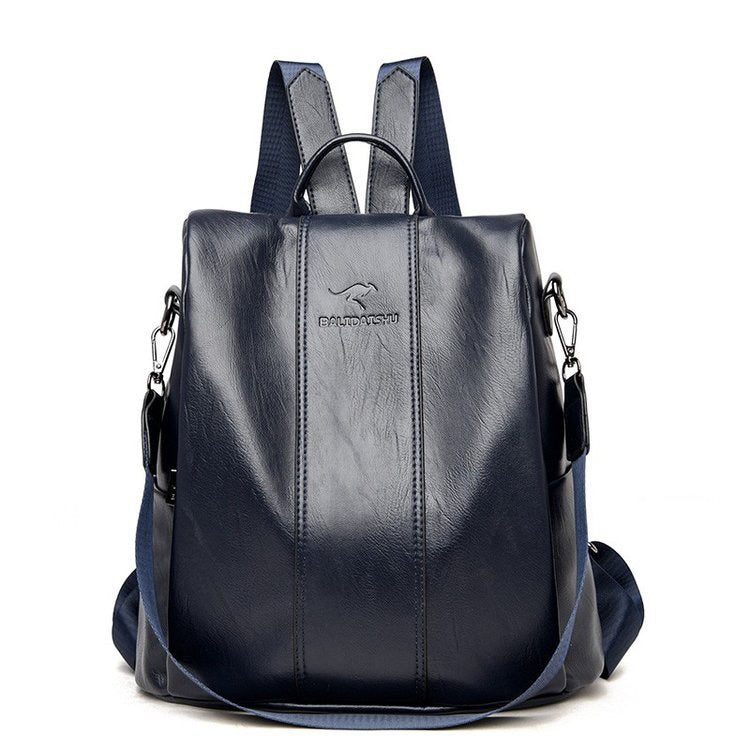 Dark navy blue soft leather women's travel backpack with a top handle, adjustable straps, and branded logo.