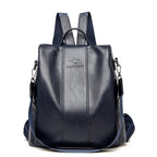 Dark navy blue soft leather women's travel backpack with a top handle, adjustable straps, and branded logo.