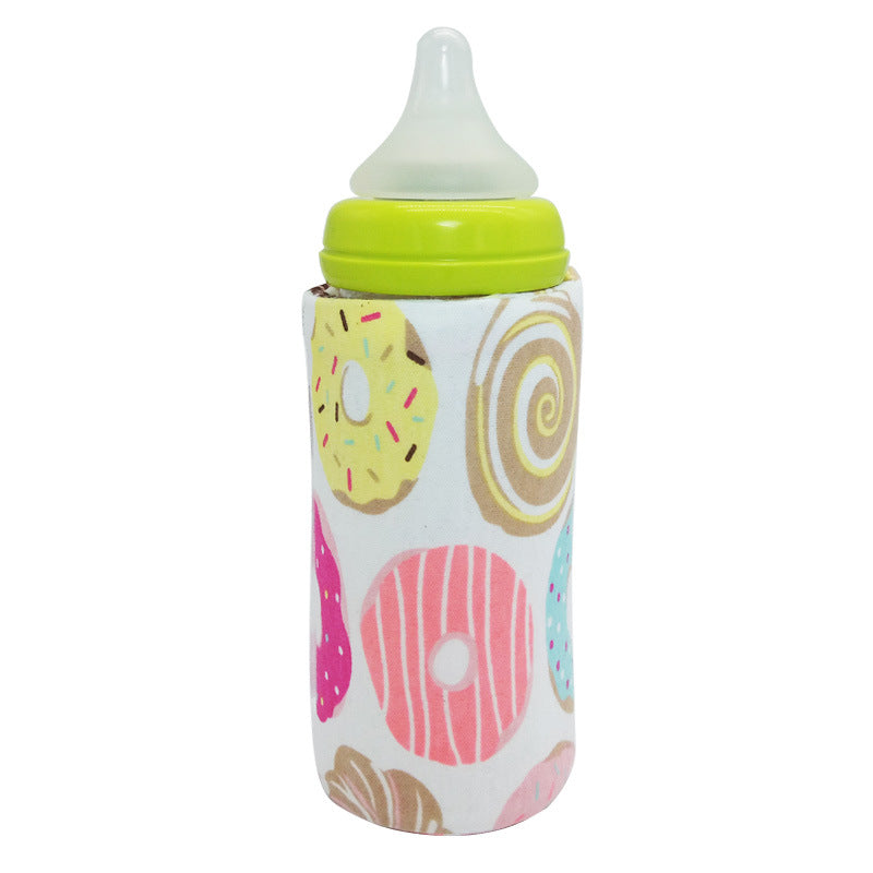 Portable baby bottle warmer sleeve with colorful donut pattern, bright green lid, and clear silicone nipple.