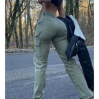 Olive green, high-waisted cargo pants with side pockets and slim-fit, stretchy material, shown from the back.