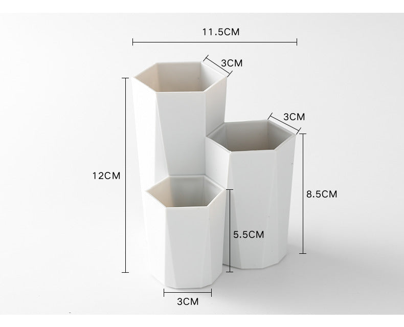 White, hexagonal makeup brush holder with three staggered compartments of varying heights and dimensions.