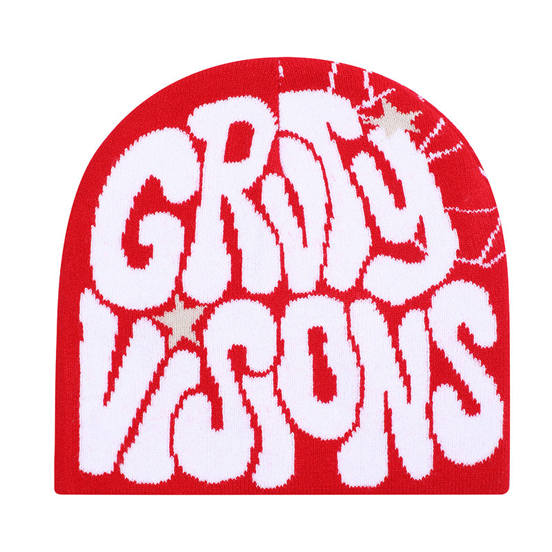 Red knit beanie with white graffiti-style "GROOVY VISIONS" lettering and subtle star accents.