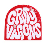 Red knit beanie with white graffiti-style "GROOVY VISIONS" lettering and subtle star accents.
